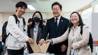 Lee Jae-myung (2nd R), the presidential candidate for South Korea's Democratic Party, casts his early vote for the upcoming presidential election at a polling station in Seoul as the Presedential elections on May 29, 2025. AFP