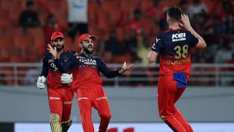 Royal Challengers Bengaluru pacer Josh Hazlewood celebrates with Virat Kohli after dismissing Punjab Kings captain Shreyas Iyer during Qualifier 1 in Mullanpur. Reuters