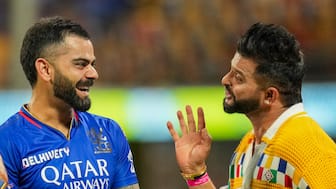 Virat Kohli and Suresh Raina share a candid moment at Bengaluru's M Chinnaswamy Stadium ahead of the Indian Premier League match between Royal Challengers Bengaluru and Chennai Super Kings on 18 May, 2024. PTI