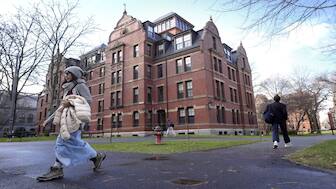 People walk between buildings on the campus of Harvard University in Cambridge. File image/AP