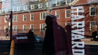 Harvard University is reflected in the window of a merchandise store across the street from the school in Cambridge, Massachusetts. AFP