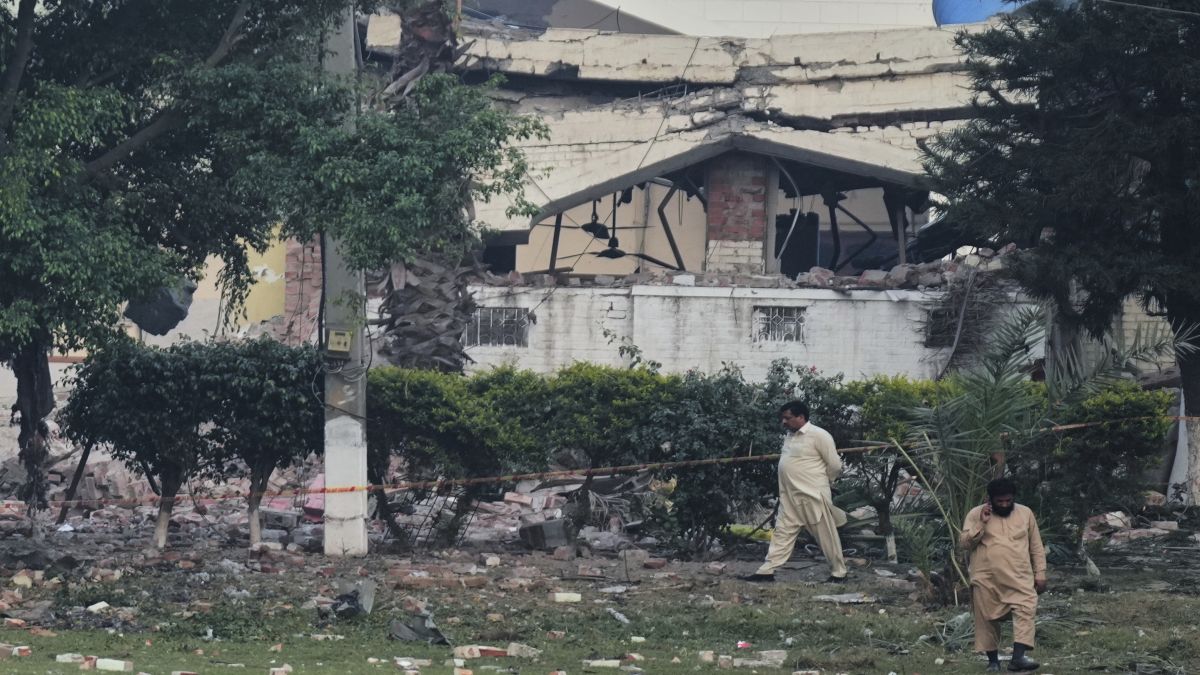 Local residents walk through rubble of a building damaged during India's Operation Sindoor in Muridke, a town in Pakistan's Punjab province. AP Local residents walk through rubble of a building damaged during India's Operation Sindoor in Muridke, a town in Pakistan's Punjab province. AP