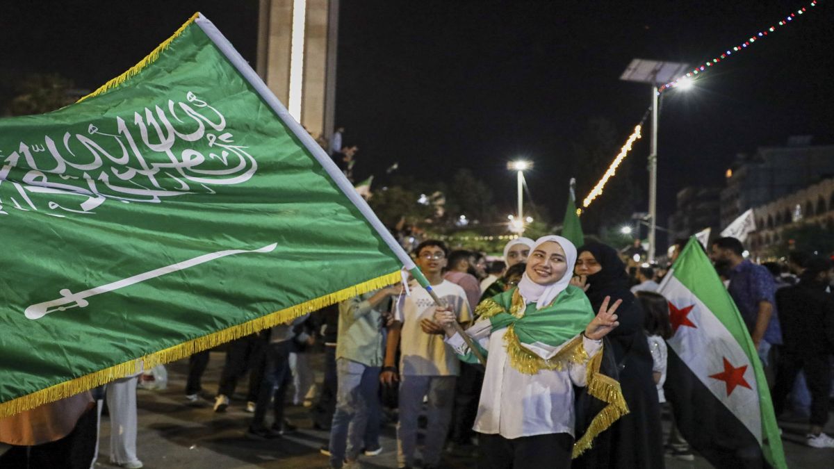 A girl holds a Saudi flag in Homs, Syria, as she celebrates US President Donald Trump's plan to ease sanctions on Syria and normalise relations with its new government. AP A girl holds a Saudi flag in Homs, Syria, as she celebrates US President Donald Trump's plan to ease sanctions on Syria and normalise relations with its new government. AP