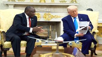 President Donald Trump confronts South Africa's President Cyril Ramaphosa in the Oval Office of the White House with printouts of White people being allegedly attacked in South Africa. AP
