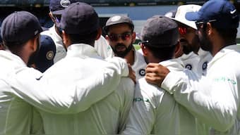Virat Kohli talks to his players in team huddle before a match. Image: AFP