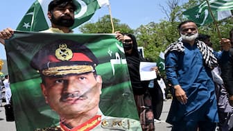 A man carries a portrait of Pakistani army chief General Syed Asim Munir, during a rally to express solidarity with Pakistan's armed forces, in Islamabad. This week, Munir became only the second in the country's history to be elevated to Field Marshal. AFP