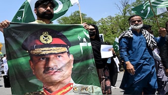 A man carries a portrait of Pakistani army chief Field Marshal Syed Asim Munir, during a rally to express solidarity with Pakistan's armed forces, in Islamabad. AFP