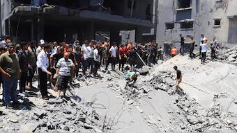 Palestinians search for casualties at the site of an Israeli strike on a house, in Gaza City. Reuters