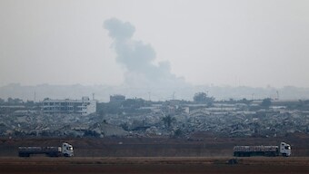 Trucks loaded with aid drive on the Israel-Gaza border as they make their way into Gaza, as seen from Israel. Reuters