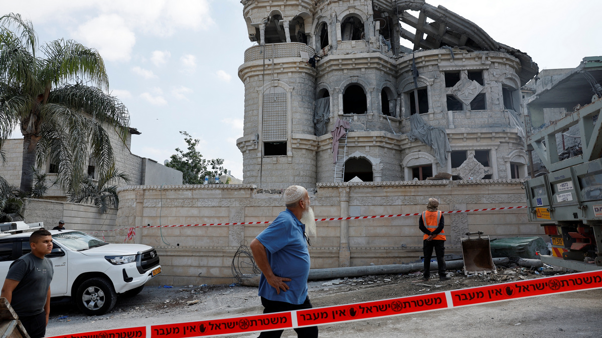 A man walks after missiles fired from Iran impacted on a residential building in northern Israel in Tamra. Reuters A man walks after missiles fired from Iran impacted on a residential building in northern Israel in Tamra. Reuters