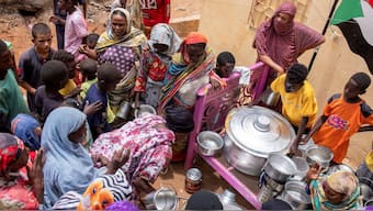(File) Sudanese women from community kitchens run by local volunteers distribute meals for people who are affected by conflict and extreme hunger and are out of reach of international aid efforts, in Omdurman, Sudan. Reuters