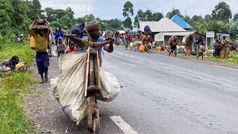 A Congolese civilian pushes a Tshukudu (a wooden bike used for transporting goods) as they flee near the Congolese border with Rwanda after fightings broke out in Kibumba, outside Goma in the North Kivu province of the Democratic Republic of Congo. File image/ Reuters