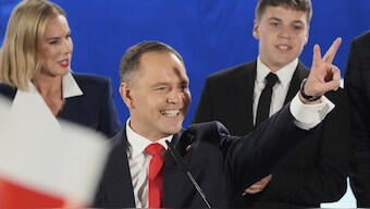 Presidential candidate Karol Nawrocki, a conservative historian backed by the right-wing Law and Justice party greets supporters as he arrives at his headquarters after the presidential election runoff in Warsaw, Poland. AP