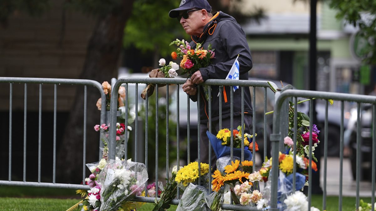 A man affixes a bouquet of flowers to a makeshift memorial for victims of an attack outside of the Boulder County, Colo., courthouse, in Boulder, Colo. AP A man affixes a bouquet of flowers to a makeshift memorial for victims of an attack outside of the Boulder County, Colo., courthouse, in Boulder, Colo. AP