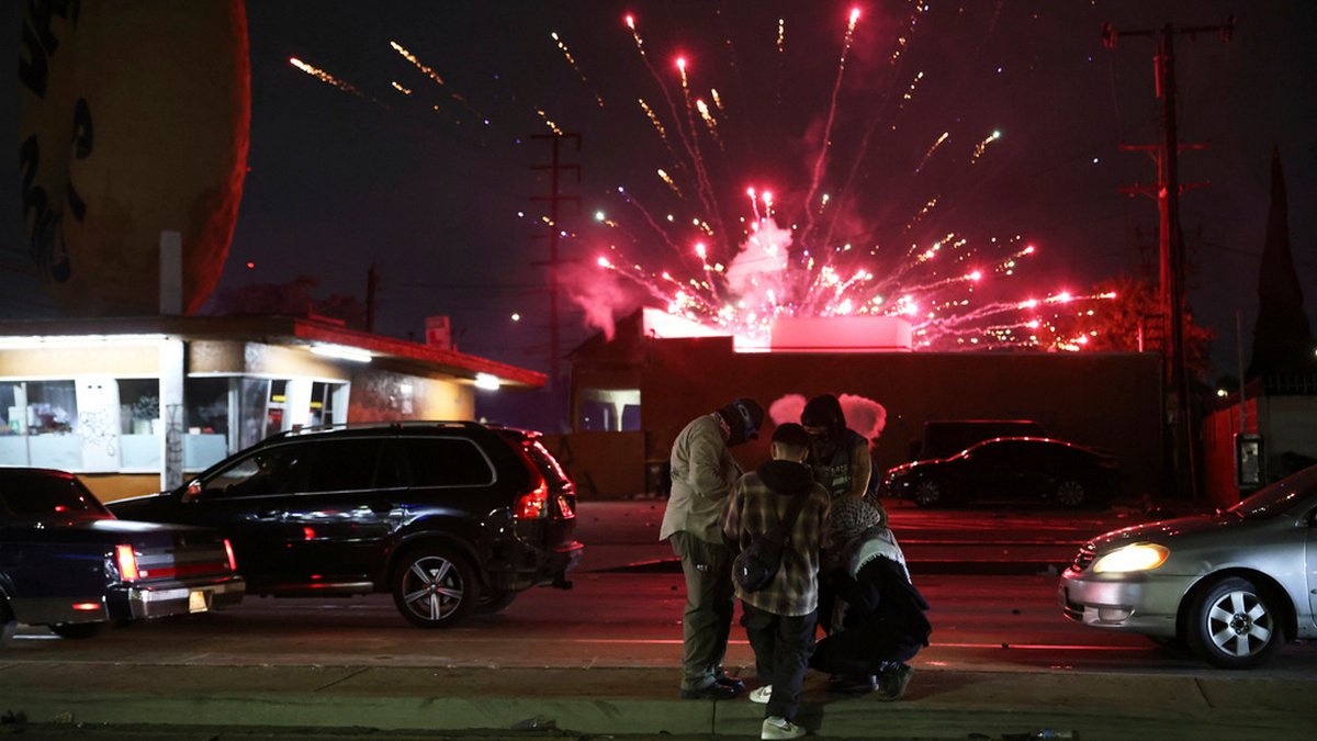 Protesters attempt to light a Molotov cocktail as a firework explodes during a protest in Compton, California on Saturday. AP Protesters attempt to light a Molotov cocktail as a firework explodes during a protest in Compton, California on Saturday. AP