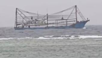 In this image made from video provided by the Armed Forces of the Philippines, Public Affairs Office, a Chinese vessel passes shallow waters off Philippines-occupied Thitu island in the disputed South China Sea. AP