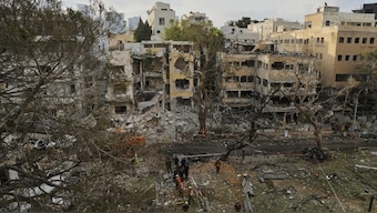 Rescue team work at the site where a missile launched from Iran struck Tel Aviv, Israel. AP