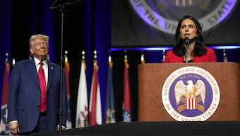 US President Donald Trump, left, looks on as US Director of National Intelligence Tulsi Gabbard of Hawaii, speaks at the National Guard Association of the United States' 146th General Conference, Monday, Aug. 26, 2024, in Detroit. File Image / AP