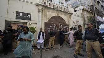 Police officers rescue members of Pakistan’s Ahmadi community from their place of worship, where supporters of Tehreek-e-Labbaik Pakistan or TLP party hold a demonstration against the Ahmadiyyas, in Karachi, Pakistan, Friday, April 18, 2025. (AP Photo/Fareed Khan)