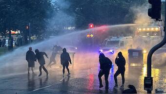  police use a water cannon near Clonavon Terrace, Ballymena, as people take part in a protest over an alleged sexual assault in the Co Antrim town. Ballymena, Tuesday June 10, 2025. AP