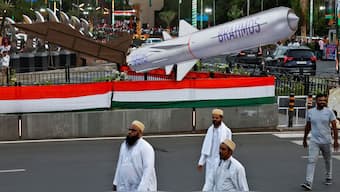 People walk past a cut-out of BrahMos missile as they arrive to attend the roadshow of Prime Minister Narendra Modi in Ahmedabad, India, May 26, 2025. File Image/Reuters