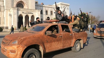 Syrian anti-regime forces celebrate as they pour into the captured central-west city of Hama on December 6, 2024, in the offensive against then-Syrian ruler Bashar al-Assad. (Photo: AFP)