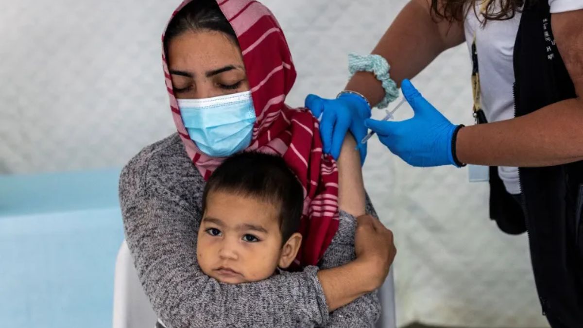 A woman holds her baby as she receives a shot of the Johnson & Johnson vaccine against the coronavirus disease (COVID-19) in the Mavrovouni camp on Lesbos, Greece. (Alkis Konstantinidis/Reuters) A woman holds her baby as she receives a shot of the Johnson & Johnson vaccine against the coronavirus disease (COVID-19) in the Mavrovouni camp on Lesbos, Greece. (Alkis Konstantinidis/Reuters)