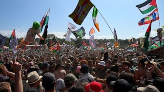 Revellers gather as Kneecap performs at Glastonbury Festival at Worthy Farm in Pilton, Somerset, UK, June 28, 2025. File Image/Reuters