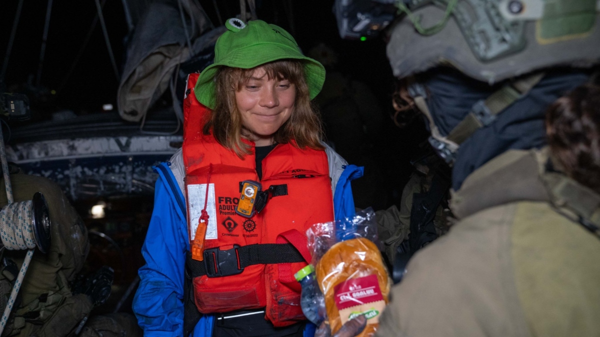 Israeli soldier offering bread to climate activist Greta Thunberg as Madleen heads to Israel. X - @IsraelMFA Israeli soldier offering bread to climate activist Greta Thunberg as Madleen heads to Israel. X - @IsraelMFA