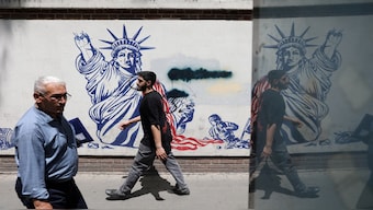 People walk past an anti-US mural on a street in Tehran, Iran, May 11, 2025. Reuters File 