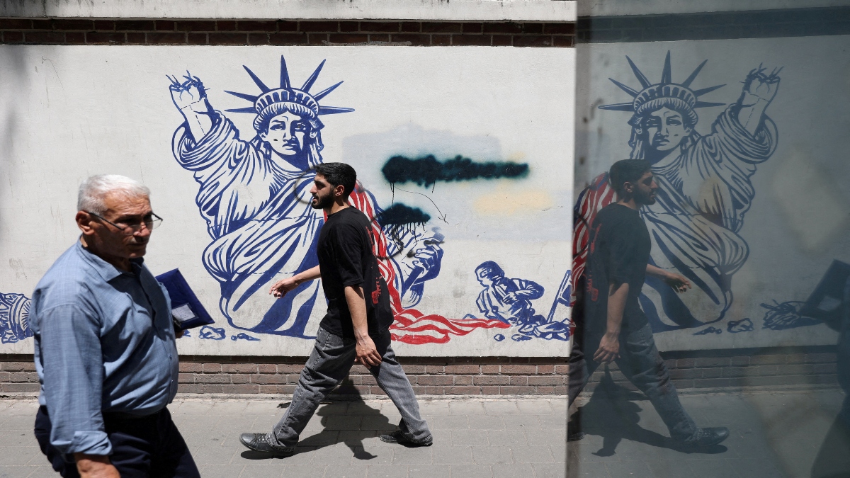 People walk past an anti-US mural on a street in Tehran, Iran, May 11, 2025. Reuters File People walk past an anti-US mural on a street in Tehran, Iran, May 11, 2025. Reuters File