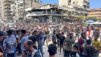 Palestinians wait to receive aid, in Gaza City, on May 25, 2025. Reuters File