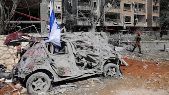 A rescue personnel walks next to a damaged vehicle at an impact site following missile attack from Iran on Israel, in Ramat Gan, Israel, June 14, 2025. File Image/Reuters