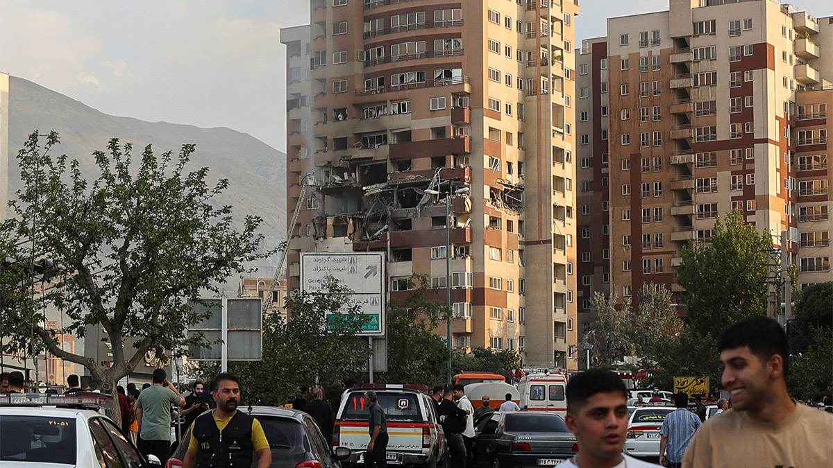 People walk near a damaged building in the aftermath of Israeli strikes, in Tehran, Iran, June 13, 2025. Reuters People walk near a damaged building in the aftermath of Israeli strikes, in Tehran, Iran, June 13, 2025. Reuters