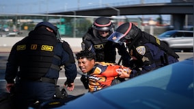 'Multiple groups continue to congregate': LA police make 'mass arrests' as protesters defy overnight curfew