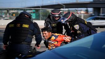 A protester is arrested by California Highway Patrol near the federal building in downtown Los Angeles on Tuesday. AP