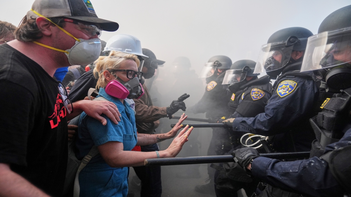Protesters confront police on the 101 Freeway near the Metropolitan Detention Center of downtown Los Angeles, on Sunday, following last night's immigration raid protest. AP Protesters confront police on the 101 Freeway near the Metropolitan Detention Center of downtown Los Angeles, on Sunday, following last night's immigration raid protest. AP