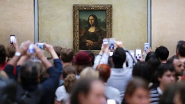 Tourists click images of the Mona Lisa at the Louvre Museum in Paris. File image/AP