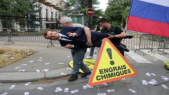 Greenpeace environmental activists set up a wax statue of French President Emmanuel Macron - they say to have stolen from the Musee Grevin - during an action against France's gas and fertilizer imports from Russia, outside the Russian Embassy in Paris on Monday. AFP