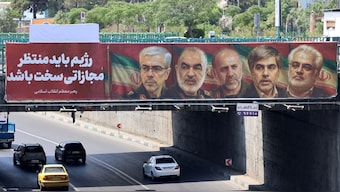 A poster displaying the portraits of Iranian military generals and nuclear scientists, killed in Israel's attack early on June 13, hangs on a bridge in Tehran on June 14, 2025.  Image- AFP