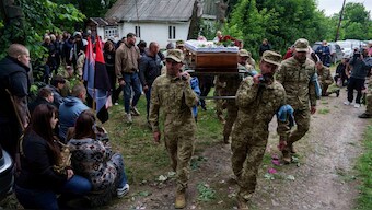 An honor guard carries the coffin of Dmytro Shapovalov, a Ukrainian serviceman, during his funeral ceremony in Yosypivka village, Vinnytsia region, Ukraine, on Friday, June 13, 2025. (AP Photo)