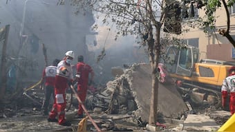 This handout picture released by the Iranian Red Crescent on June 14, 2025, show Iranian Red Crescent volunteers working in a Tehran neighbourhood hit by a reported Israeli strike. Image- AFP