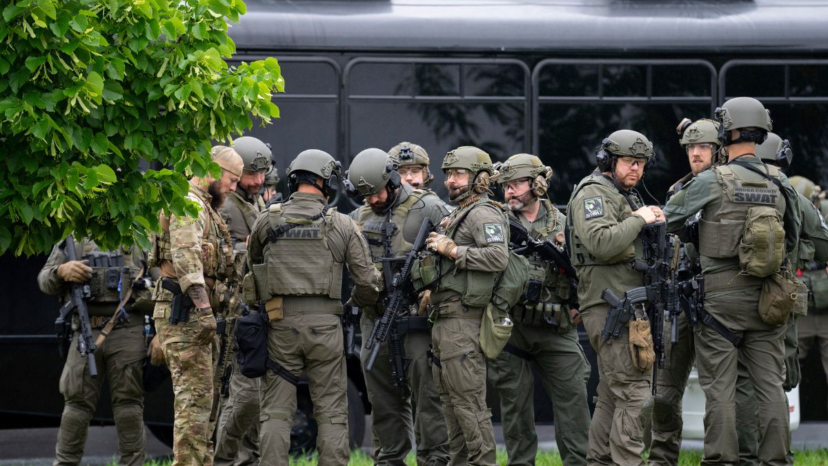 Law enforcement officers including local police, sheriffs and the FBI, stage less than a mile from a shooting in Brooklyn Park, Minn. on Saturday, June 14, 2025. Image- AP Law enforcement officers including local police, sheriffs and the FBI, stage less than a mile from a shooting in Brooklyn Park, Minn. on Saturday, June 14, 2025. Image- AP
