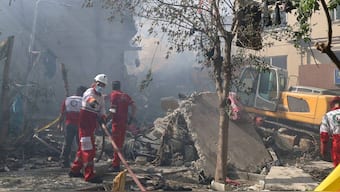 This handout picture released by the Iranian Red Crescent on June 14, 2025, show Iranian Red Crescent volunteers working in a Tehran neighbourhood hit by a reported Israeli strike.  (Photo by Iranian Red Crescent / AFP)
