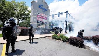 Police break up a crowed during a "No Kings" protest in Dekalb County, near Atlanta, Saturday, June 14, 2025. (AP Photo)