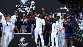 Pacer Kagiso Rabada holds the ICC Test Mace aloft as he celebrates South Africa's triumph in the World Test Championship final against Australia at Lord's with teammates. Reuters