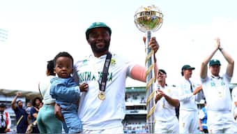 Temba Bavuma holds the ICC Test Mace poses with the ICC Test Mace with his son in his arm after leading South Africa to a five-wicket victory over Australia in the World Test Championship Final at Lord's. Reuters