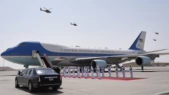 Qatar Air Force Apache gunships perform a flyover as Air Force One is ready to depart from Al Udeid Air Base in Doha, Qatar. AP