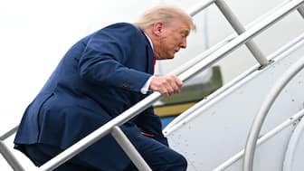 Trump stumbled as he made his way up the stairs of Air Force One on Sunday. AFP