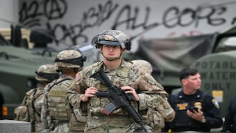 Members of the California National Guard stand watch outside the Edward R. Roybal Federal Building on Tuesday, following another day of protests in response to federal immigration operations in Los Angeles. Hundreds of Marines are due to arrive in Los Angeles on Tuesday after US President Donald Trump ordered their deployment in response to protests against immigration arrests and despite objections by state officials. AFP